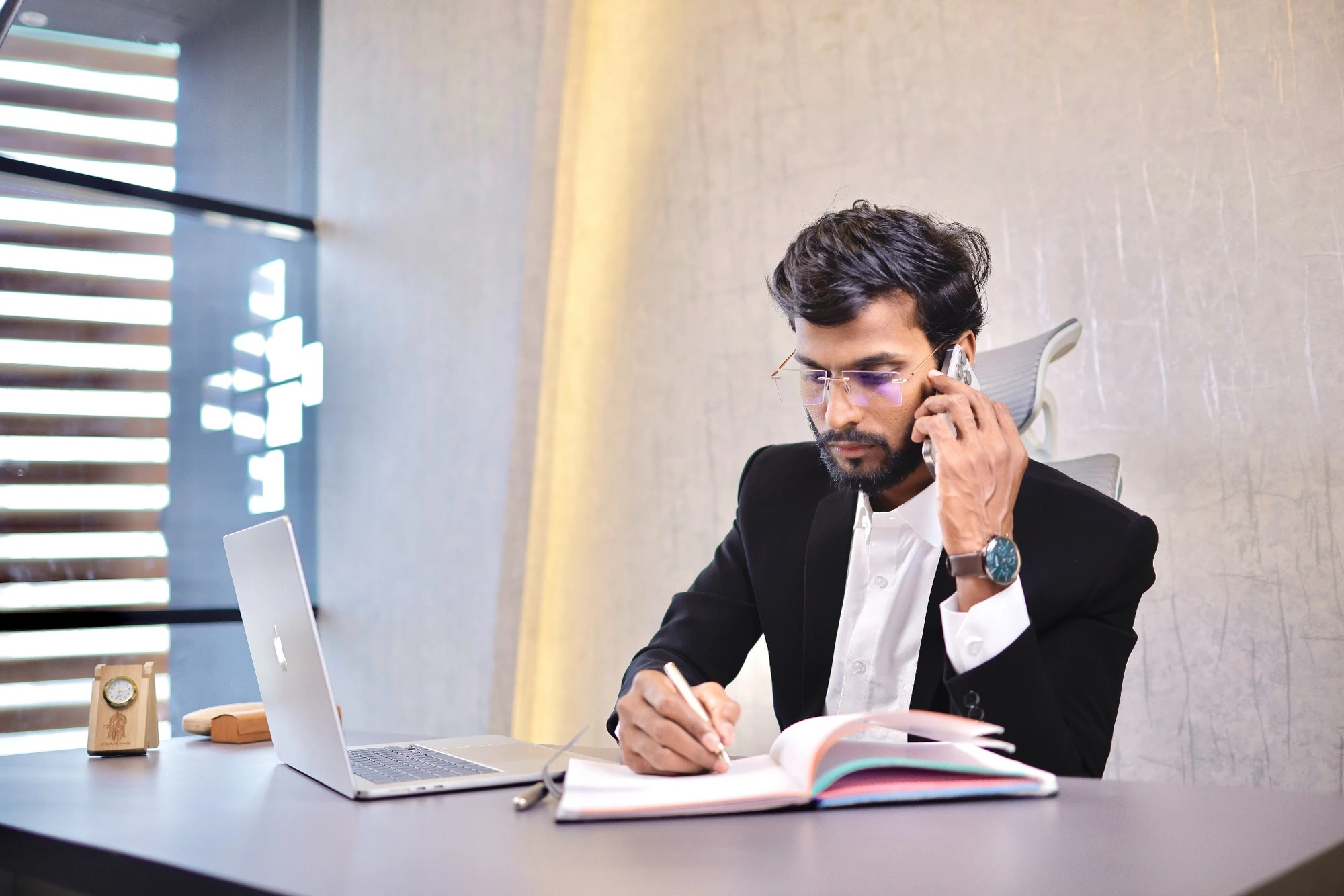 Arif Mulani — Founder & CEO of AM Group of Education at his office desk